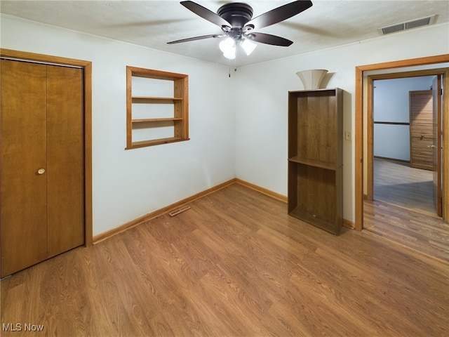 spare room featuring hardwood / wood-style floors and ceiling fan