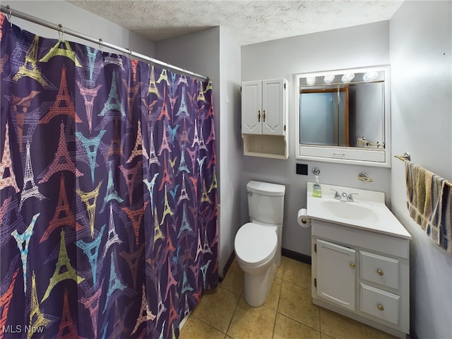 bathroom featuring tile patterned flooring, a textured ceiling, walk in shower, vanity, and toilet