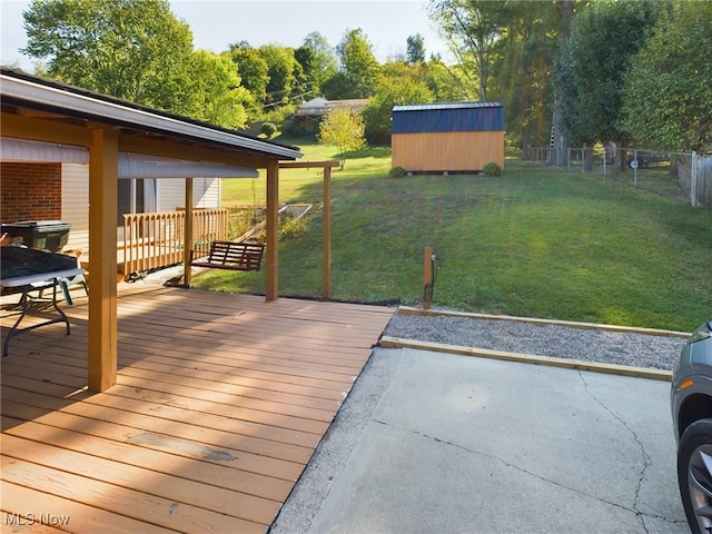 deck with a lawn and a storage shed