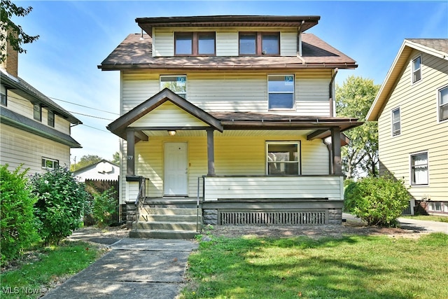 view of front facade with a front yard and a porch