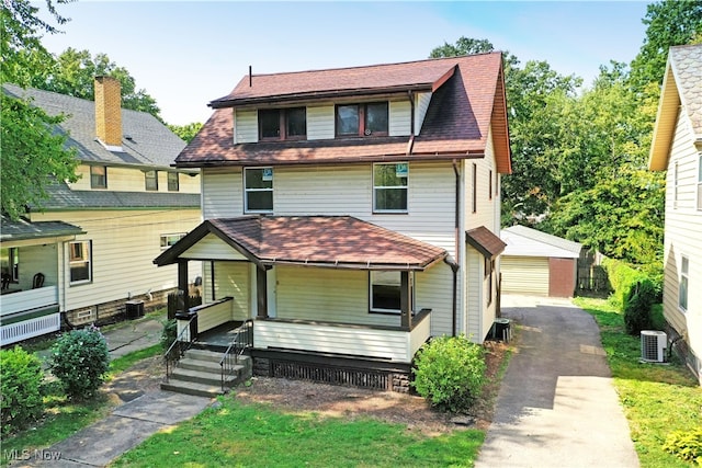 view of front of home with central AC, an outdoor structure, a garage, and a porch