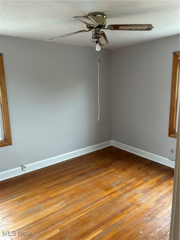 spare room with ceiling fan, hardwood / wood-style floors, and a textured ceiling