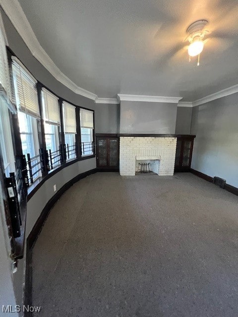 unfurnished living room featuring ornamental molding, carpet, ceiling fan, and a fireplace