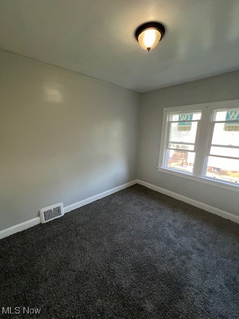 empty room with dark carpet