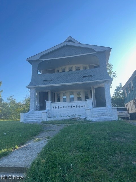 view of front of property with a front yard and a porch