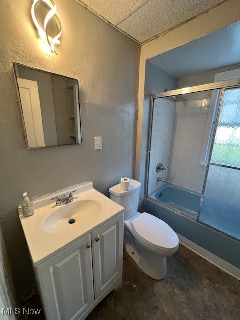 full bathroom with enclosed tub / shower combo, vanity, a drop ceiling, and toilet