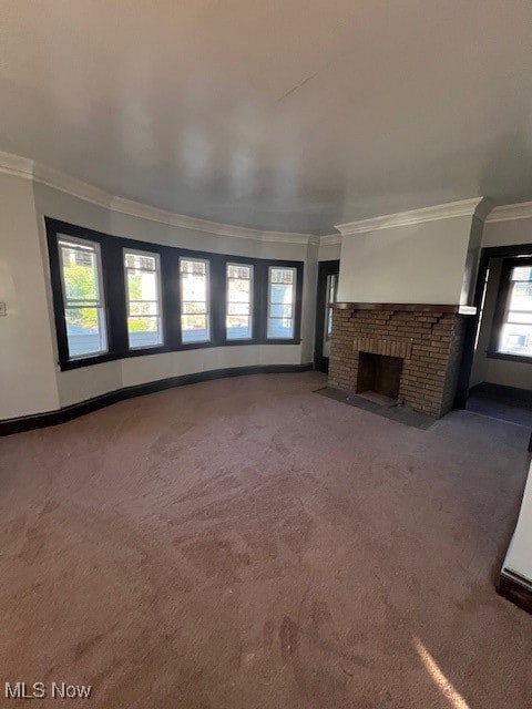 unfurnished living room with carpet flooring, a fireplace, and ornamental molding