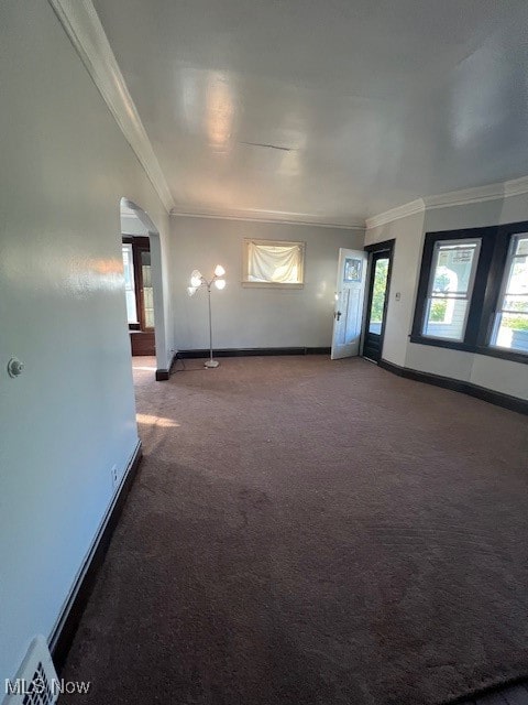 unfurnished living room featuring crown molding and carpet flooring