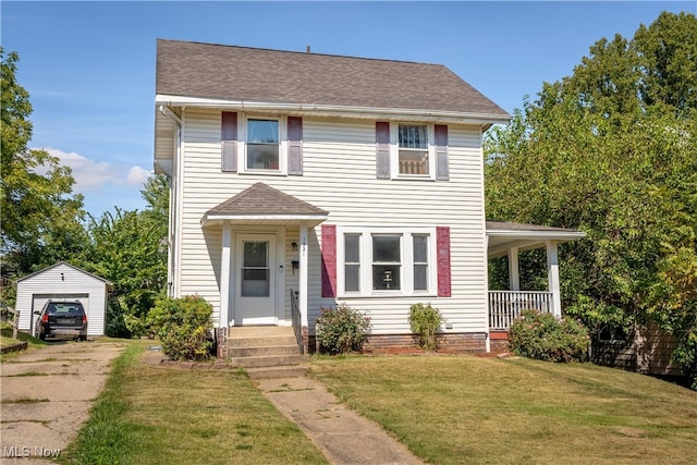 view of front facade featuring a front yard, covered porch, an outdoor structure, and a garage