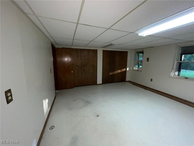 interior space with wooden walls and a paneled ceiling