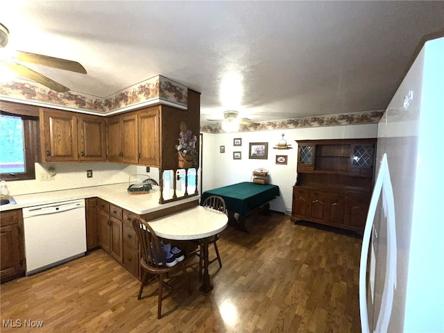 kitchen featuring white appliances, dark hardwood / wood-style floors, and ceiling fan