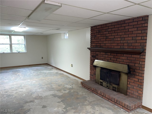 basement featuring a fireplace and a drop ceiling