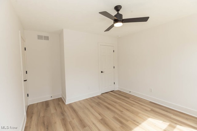 spare room featuring light wood-type flooring and ceiling fan