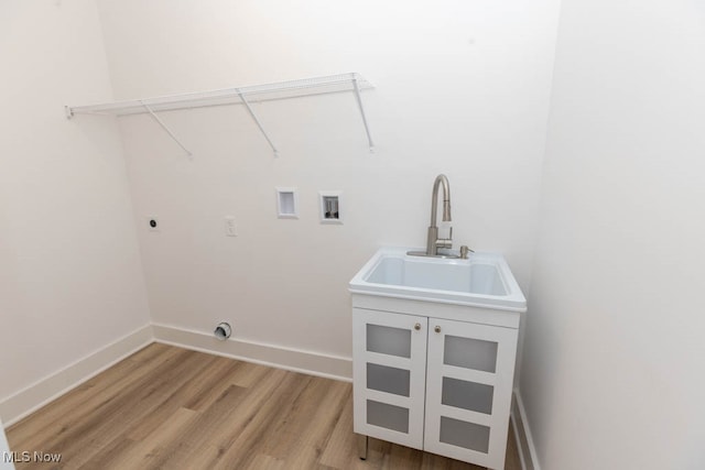 washroom with cabinets, light wood-type flooring, washer hookup, sink, and electric dryer hookup