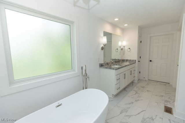 bathroom featuring a bath and vanity