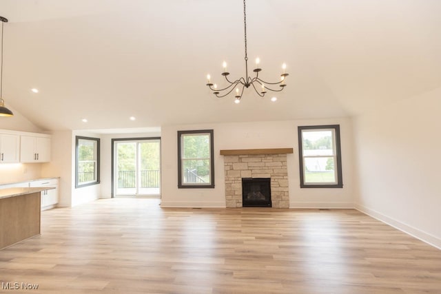 unfurnished living room with light hardwood / wood-style flooring, a fireplace, and a wealth of natural light