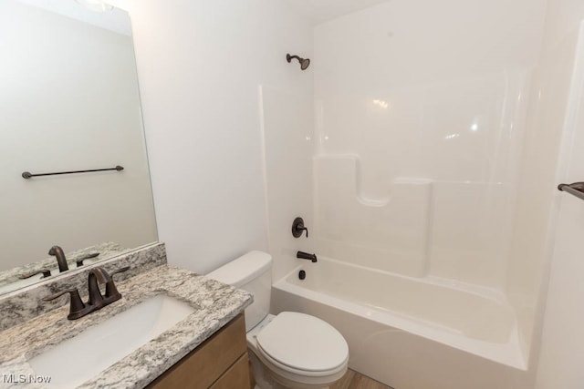 full bathroom featuring vanity, toilet, and  shower combination