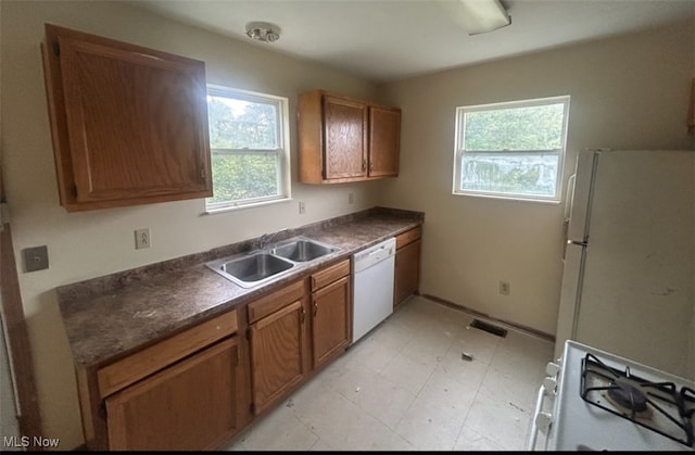 kitchen featuring white appliances and sink