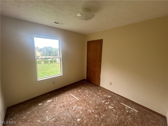 empty room with a textured ceiling