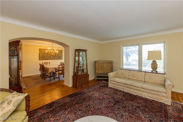 living room with wood-type flooring and a chandelier