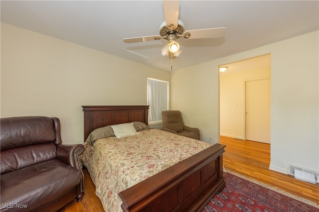 bedroom with ceiling fan and hardwood / wood-style floors