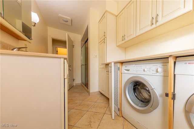 laundry area featuring washer / dryer and light tile patterned floors