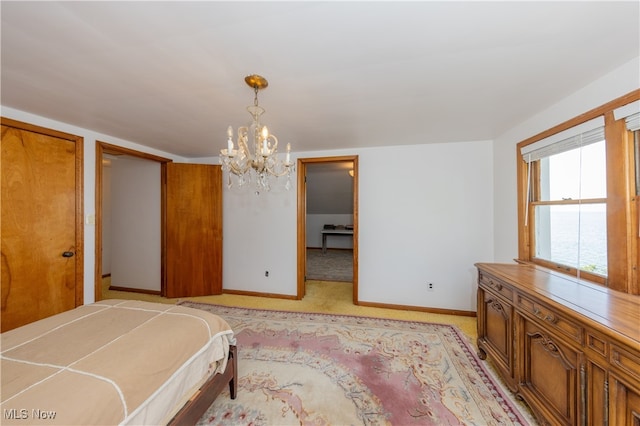 bedroom featuring light carpet, a notable chandelier, and a closet