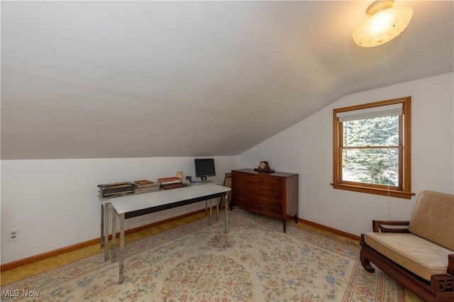 office space featuring lofted ceiling and light colored carpet