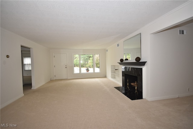 carpeted living room with a high end fireplace and crown molding