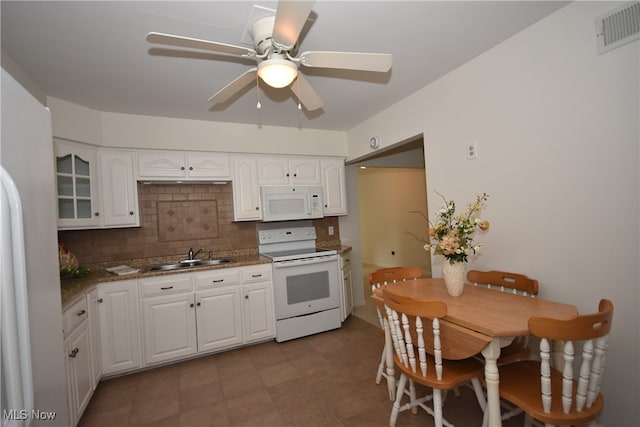 kitchen with tasteful backsplash, white cabinets, white appliances, ceiling fan, and sink