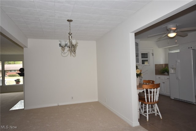 carpeted dining area with ceiling fan with notable chandelier