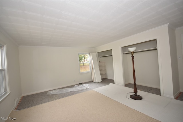 unfurnished bedroom featuring carpet floors and crown molding