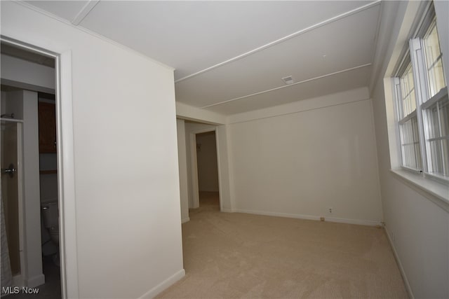 unfurnished room featuring light colored carpet