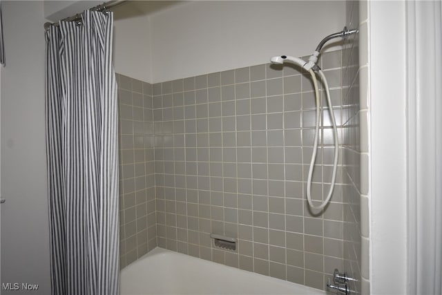 bathroom with shower / bath combo with shower curtain