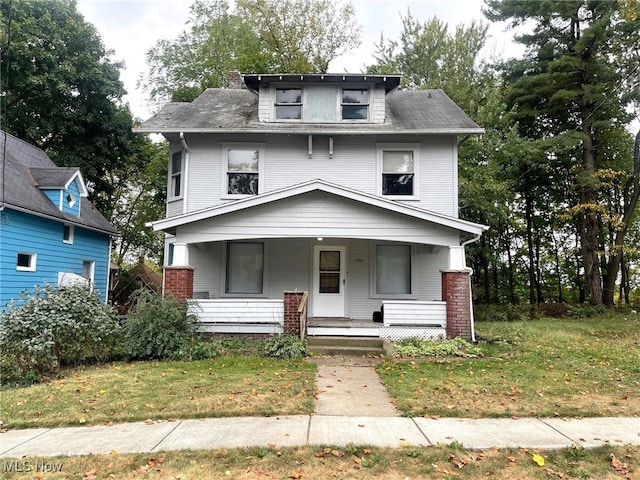 view of front of home featuring a front lawn and covered porch