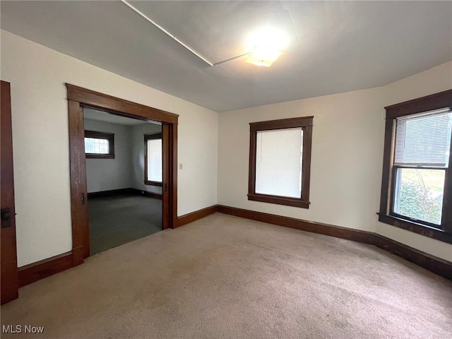 unfurnished room featuring light carpet and a healthy amount of sunlight