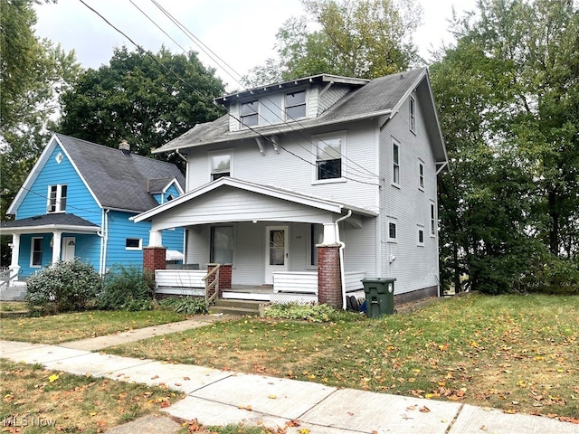 view of front facade with a front yard and a porch