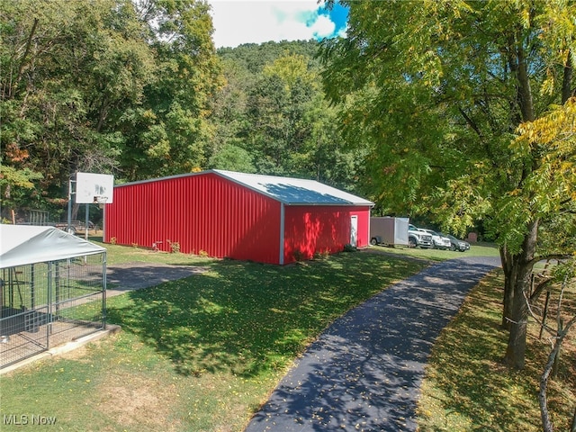 view of outbuilding with a lawn