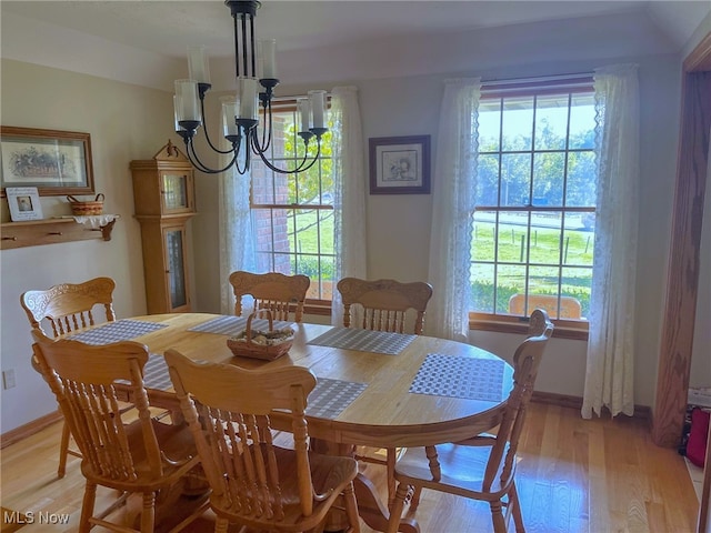 dining area with a notable chandelier and light wood-type flooring