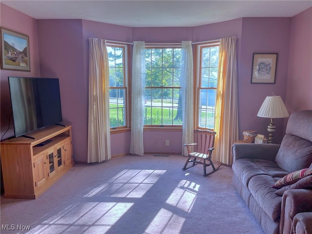 living room featuring light carpet and a wealth of natural light