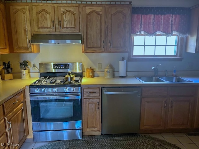 kitchen featuring appliances with stainless steel finishes, sink, and light tile patterned floors