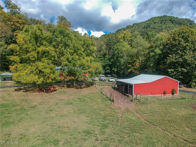 view of yard with an outbuilding and a rural view