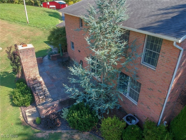 exterior space with cooling unit, a lawn, and a patio