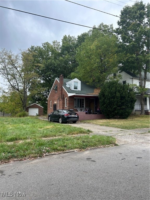 view of front of property with a garage and an outbuilding