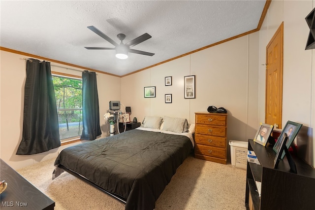 bedroom featuring a textured ceiling, crown molding, ceiling fan, and light colored carpet