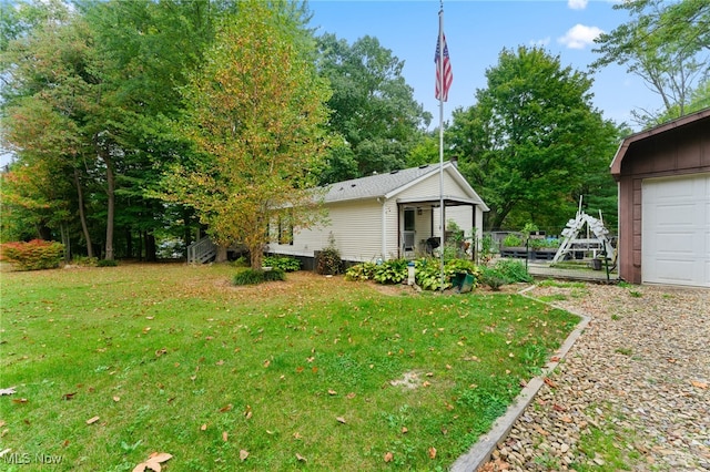 view of yard with an outdoor structure and a garage