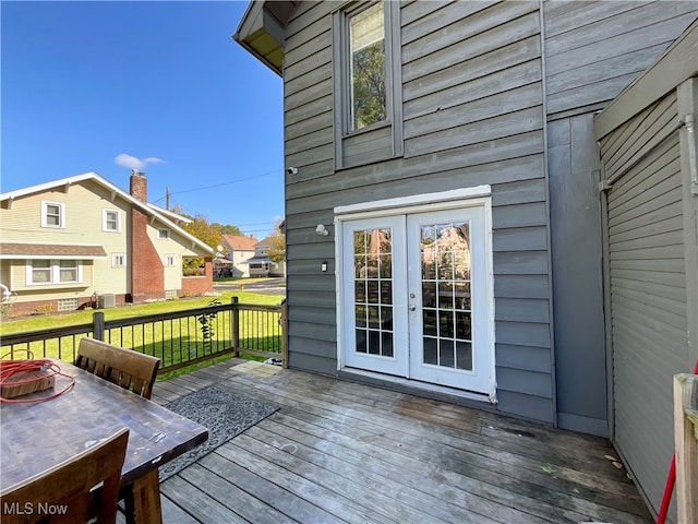 wooden deck featuring a lawn