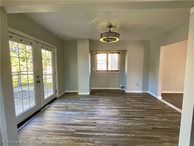 empty room featuring dark wood-type flooring and french doors