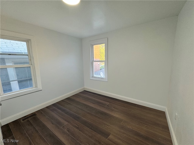 empty room featuring dark wood-type flooring