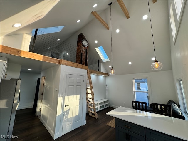 kitchen featuring high vaulted ceiling, a skylight, and pendant lighting